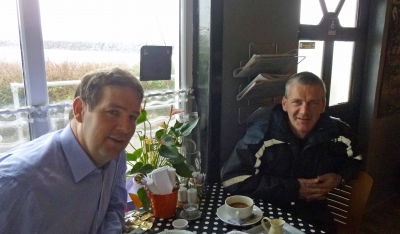 Cllr Donal Cunningham catching up with Michael Cecil, Chair of the Rathlin Development and Community Association over a Fairtrade coffee in the Water Shed Cafe, Rathlin Island._0.jpg